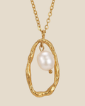 Freshwater pearl suspended in an open gold-tone pendant frame on a fine chain
