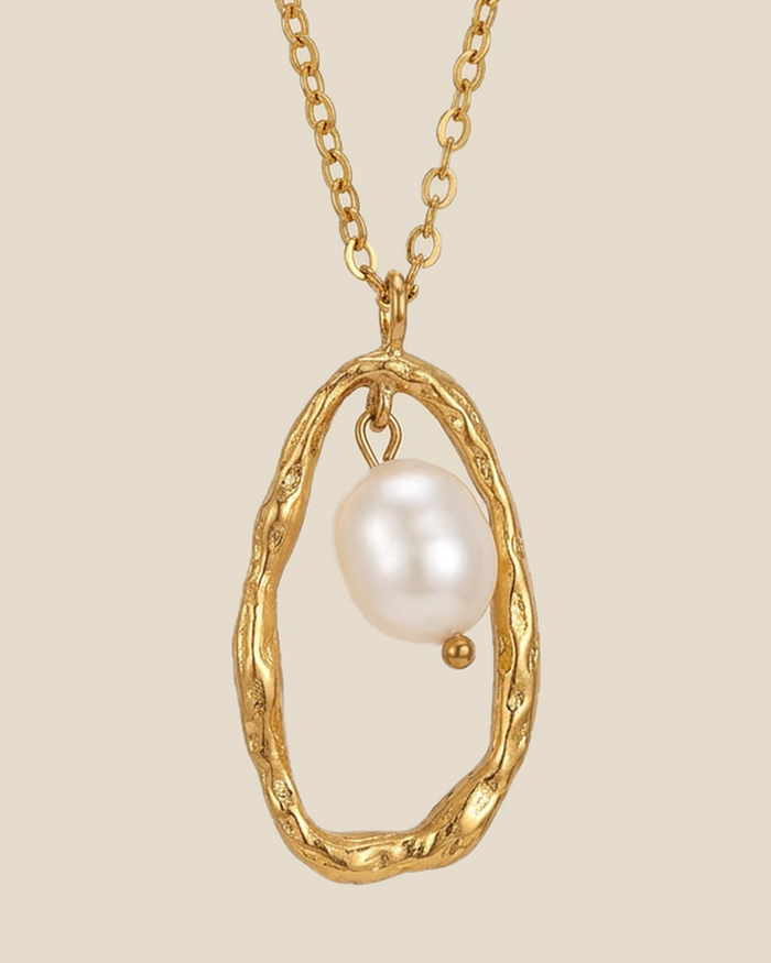 Freshwater pearl suspended in an open gold-tone pendant frame on a fine chain